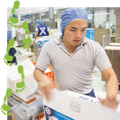 TENA factory worker closing a package TENA factory worker closing a package